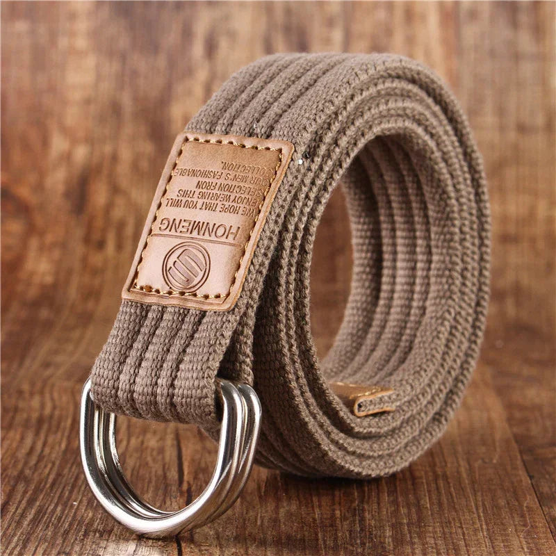Khaki woven canvas belt with double D-ring metal buckle and tan leather patch, casual style.