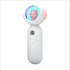White handheld device with a cat figure in a transparent dome and a camera lens below