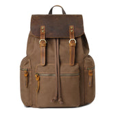 Brown canvas backpack with leather flap, multiple pockets, and adjustable straps