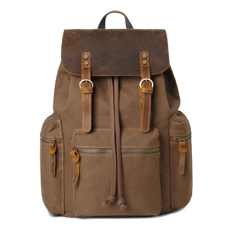 Brown canvas backpack with leather flap, multiple pockets, and adjustable straps