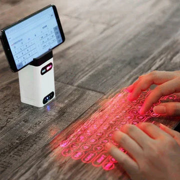 Hands typing on a red laser-projected virtual keyboard with a smartphone stand on wood table