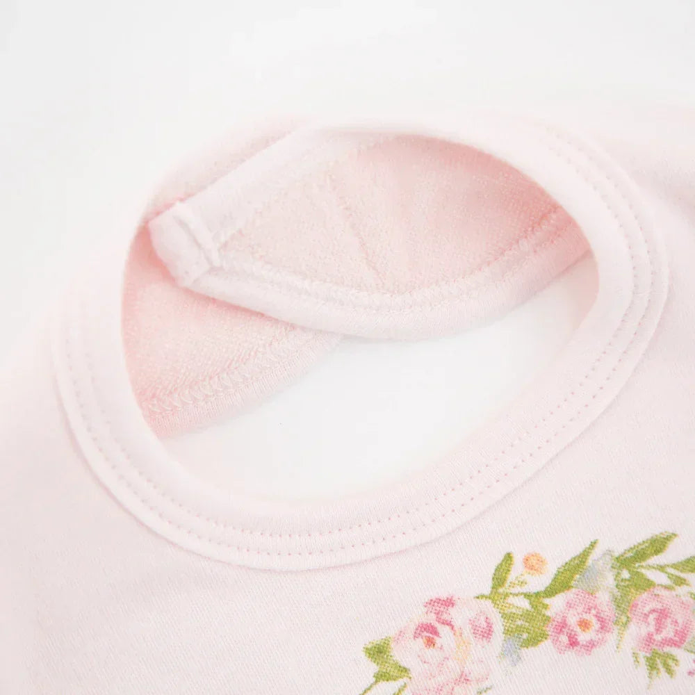 Light pink cotton t-shirt with floral print detail and soft round neckline, close-up view