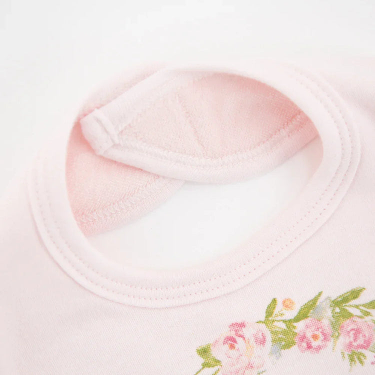 Light pink cotton t-shirt with floral print detail and soft round neckline, close-up view
