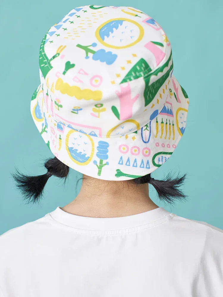Colorful patterned bucket hat in soft cotton, loose fit, worn with a white t-shirt.