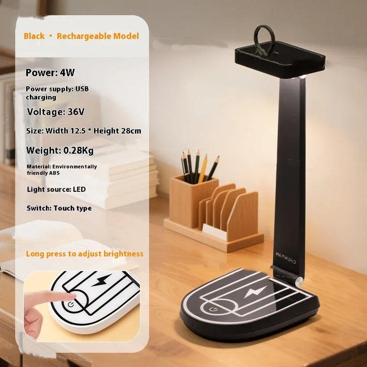 Modern black LED desk lamp with touch controls, foldable design, on wooden workspace.