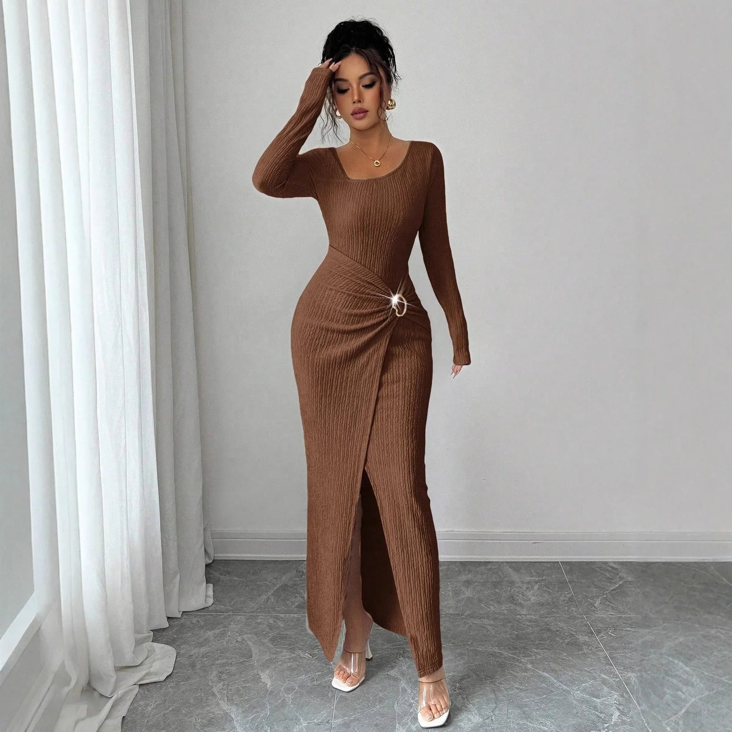 Woman wearing a brown ribbed knit long-sleeve maxi dress with side slit and bodycon fit