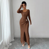 Woman wearing a brown ribbed knit long-sleeve maxi dress with side slit and bodycon fit
