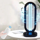 Modern UV sterilization lamp with black oval frame, blue light, and remote control on white table