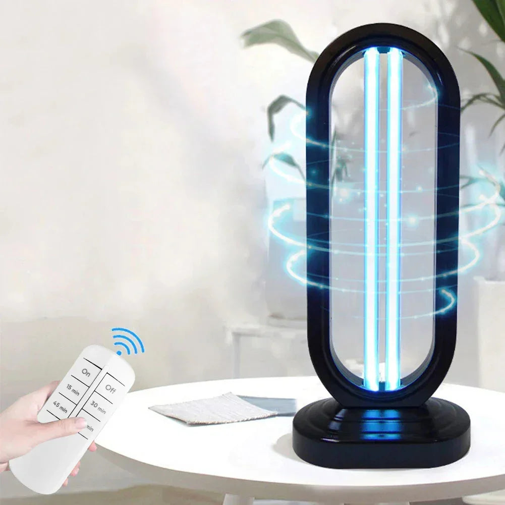 Modern UV sterilization lamp with black oval frame, blue light, and remote control on white table