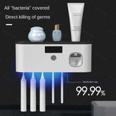Wall-mounted UV toothbrush sanitizer with slots for electric toothbrushes and blue LED sterilization light.