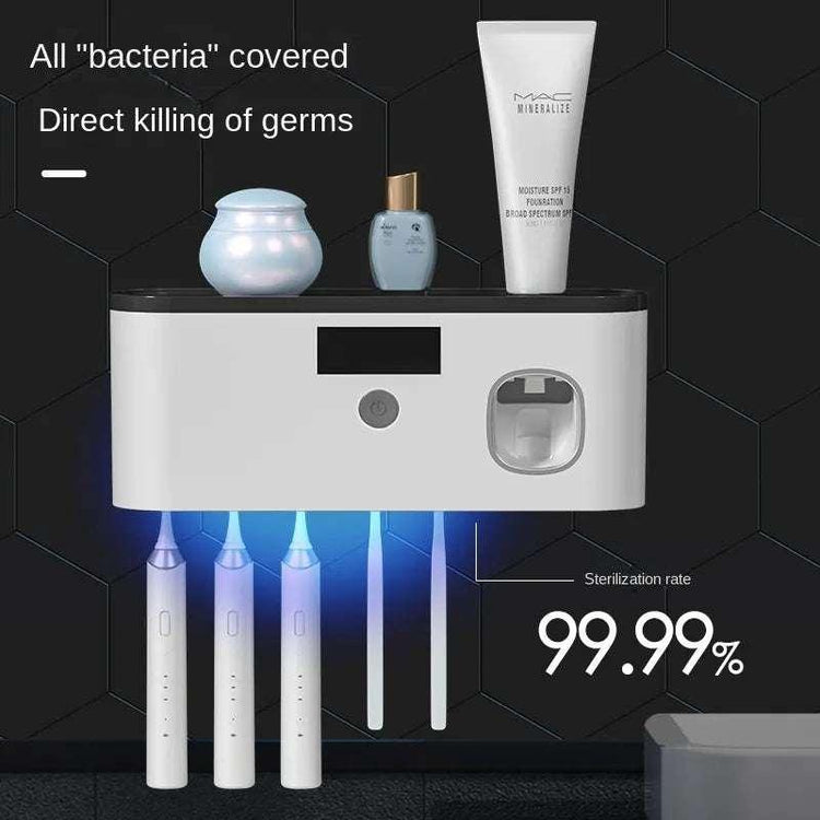 Wall-mounted UV toothbrush sanitizer with slots for electric toothbrushes and blue LED sterilization light.