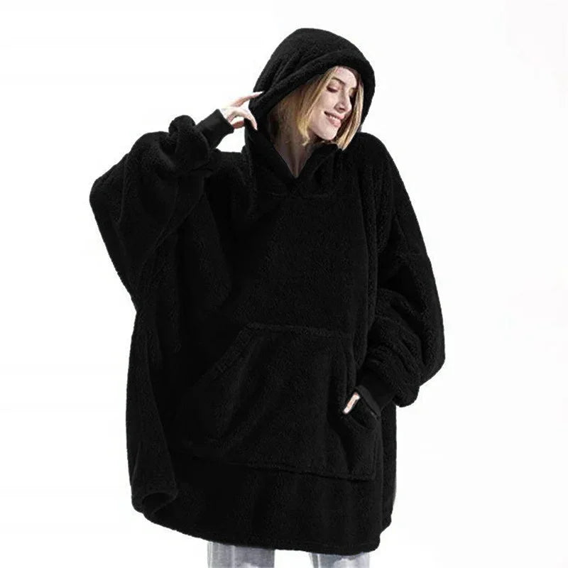 Woman wearing oversized black sherpa hoodie with kangaroo pocket and relaxed fit