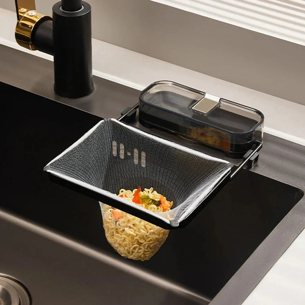 Mesh kitchen sink strainer basket in black, draining noodles and vegetables.