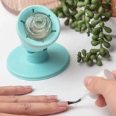 Hand applying clear nail polish, turquoise nail polish holder, succulent decor, manicure tool