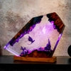 Glowing purple resin art with dragons and castle, mounted on wood base, fantasy decor piece