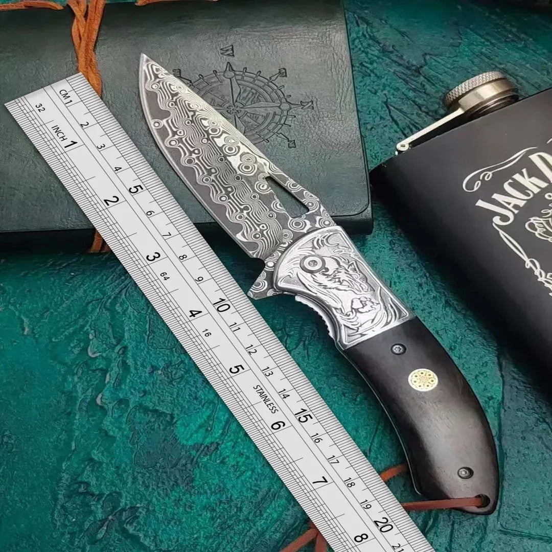 Patterned steel knife with engraved handle and dark wood grip, placed next to a ruler.