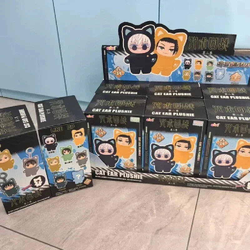 Assorted plush toy boxes featuring cat ear hooded outfits in black and orange colors.