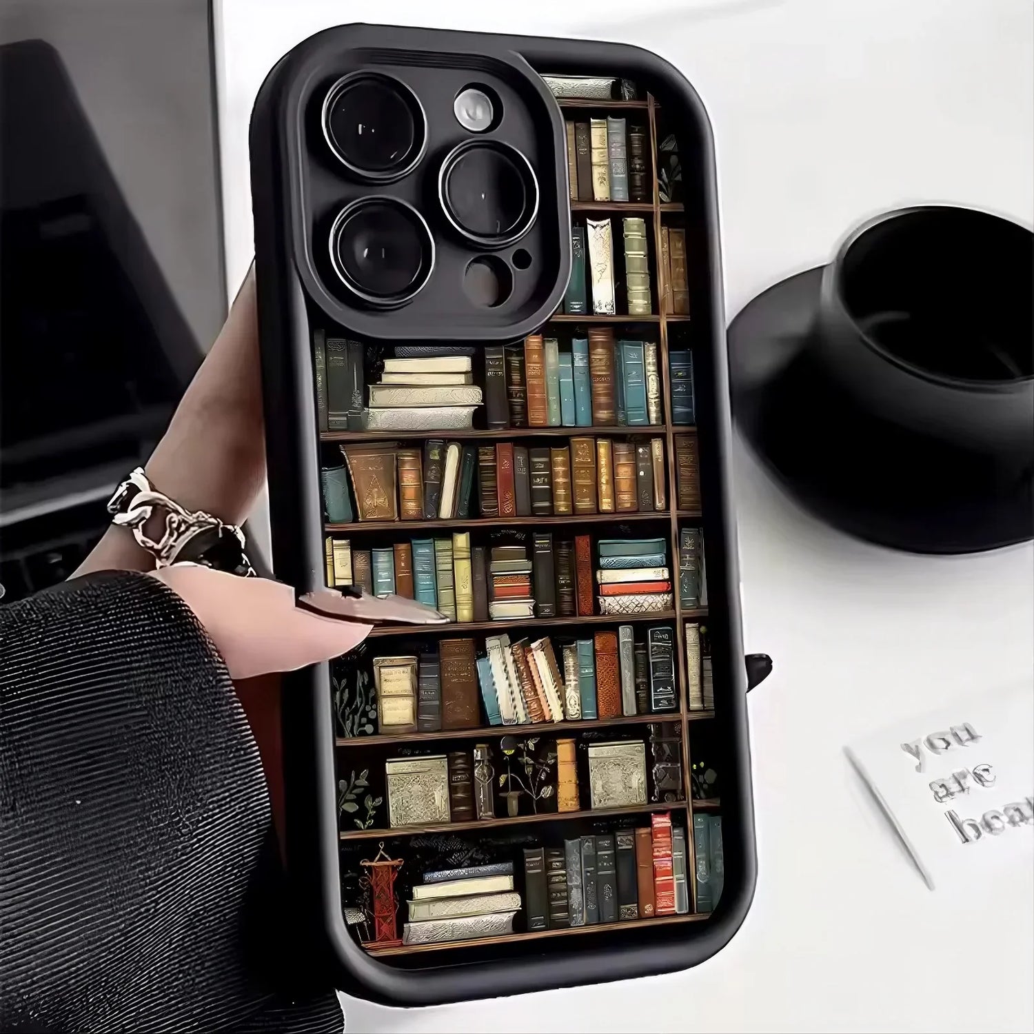 Phone case with colorful bookshelf design, hard plastic material, slim fit, streetwear style.