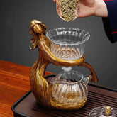 Artistic glass and resin tea set with gold sculpted figure, modern style, transparent finish