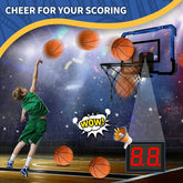 Boy in green athletic basketball uniform shooting hoops on indoor court with digital scoreboard