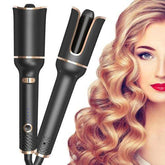 Black automatic hair curler with gold accents, creating loose voluminous curls on blonde hair