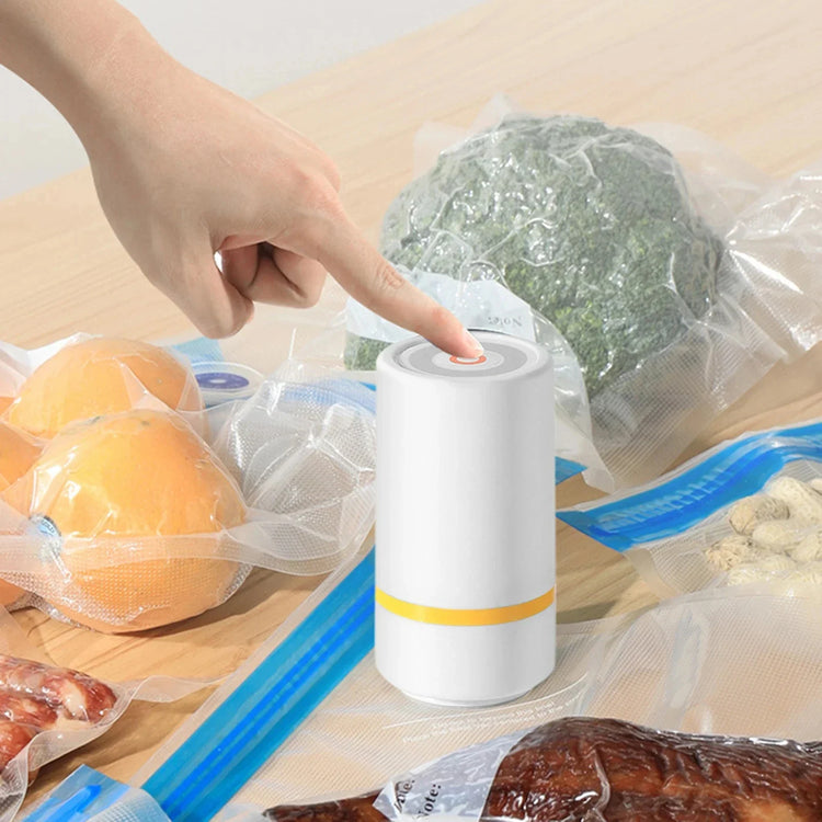 Hand using a white vacuum sealer on sealed food bags for fresh food storage