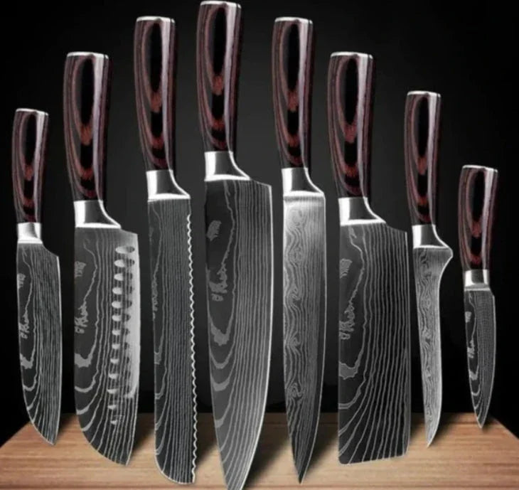 Set of eight Damascus steel kitchen knives with dark wood handles on a wooden block