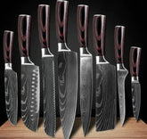 Set of eight Damascus steel kitchen knives with dark wood handles on a wooden block
