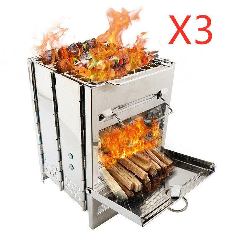 Portable stainless steel wood burning grill with skewers and active flames, compact outdoor stove.