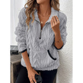 Woman wearing a light gray sherpa fleece pullover with zipper, long sleeves, and relaxed fit