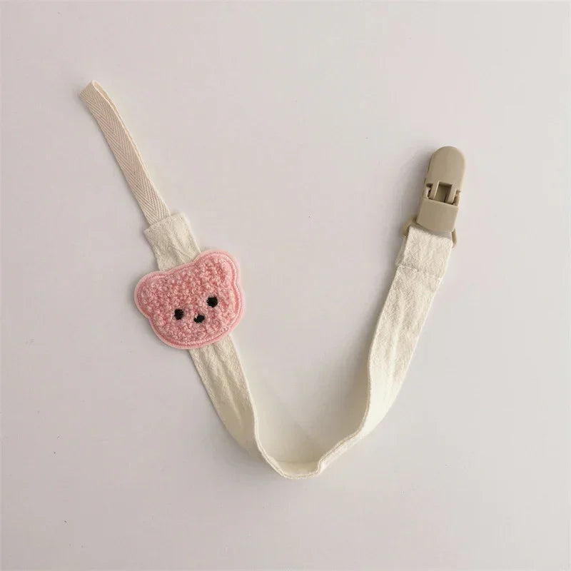 Cute cream fabric clip strap with pink crochet bear patch, playful streetwear accessory