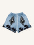 Light blue streetwear shorts with black floral and vintage portrait graphic, relaxed fit