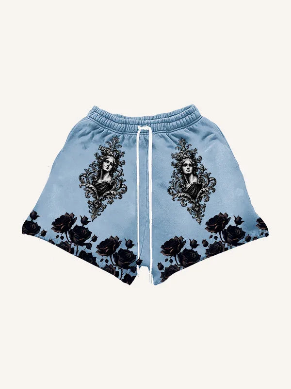 Light blue streetwear shorts with black floral and vintage portrait graphic, relaxed fit