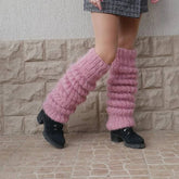 Chunky pink knit leg warmers styled with a plaid mini skirt and black platform boots