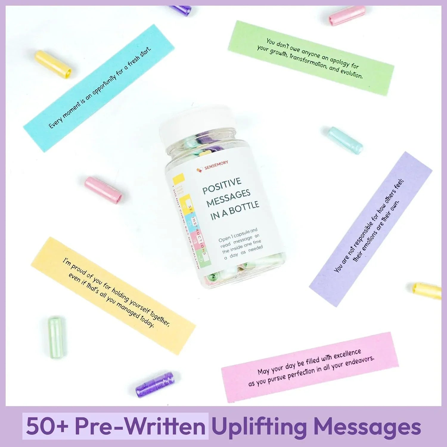 Glass bottle with colorful capsules and uplifting messages on paper slips, flat lay presentation.