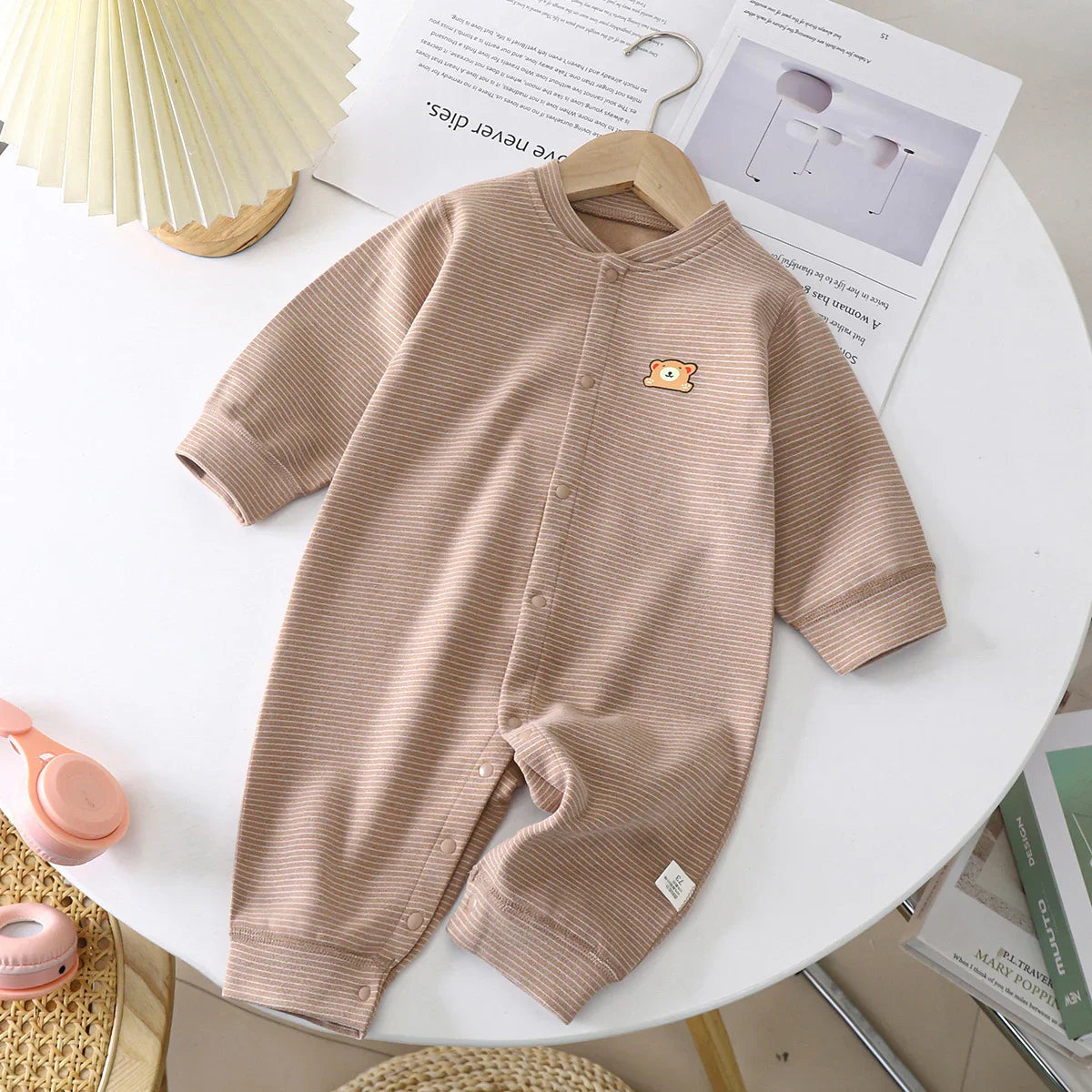 Beige ribbed baby jumpsuit with bear patch, long sleeves, snap buttons, relaxed fit