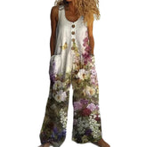 Sleeveless linen jumpsuit with wide legs, wooden buttons, and a colorful floral print.