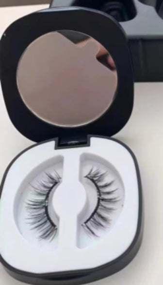 Natural-looking false eyelashes in a black compact case with mirror, lightweight synthetic material
