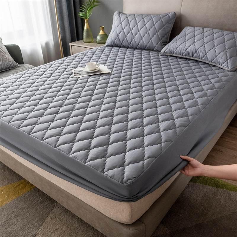 Quilted gray mattress cover set with matching pillowcases, soft padded fabric, fitted style