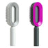 Two modern oval hairbrushes with ergonomic handles, one gray and one black with pink accent.