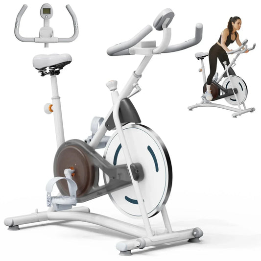 Woman wearing black fitted athletic wear using a white stationary exercise bike indoors.