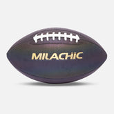 Iridescent dark purple textured football with white laces and metallic gold lettering, studio background
