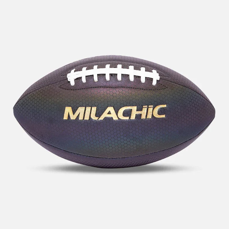 Iridescent dark purple textured football with white laces and metallic gold lettering, studio background