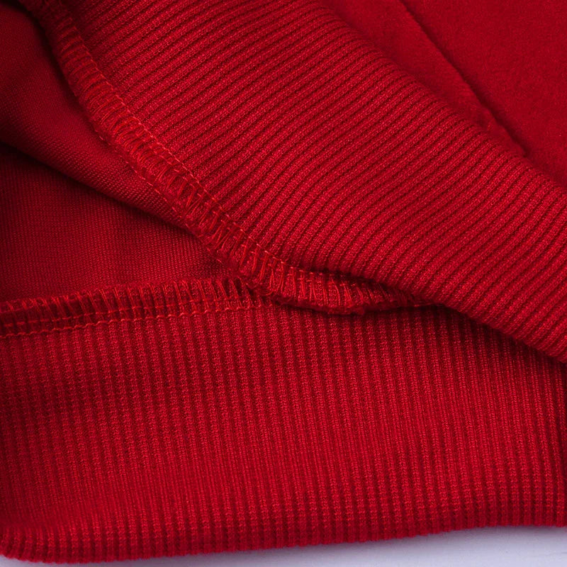 Close-up of red ribbed cotton sweatshirt cuff showing soft texture and stitching detail