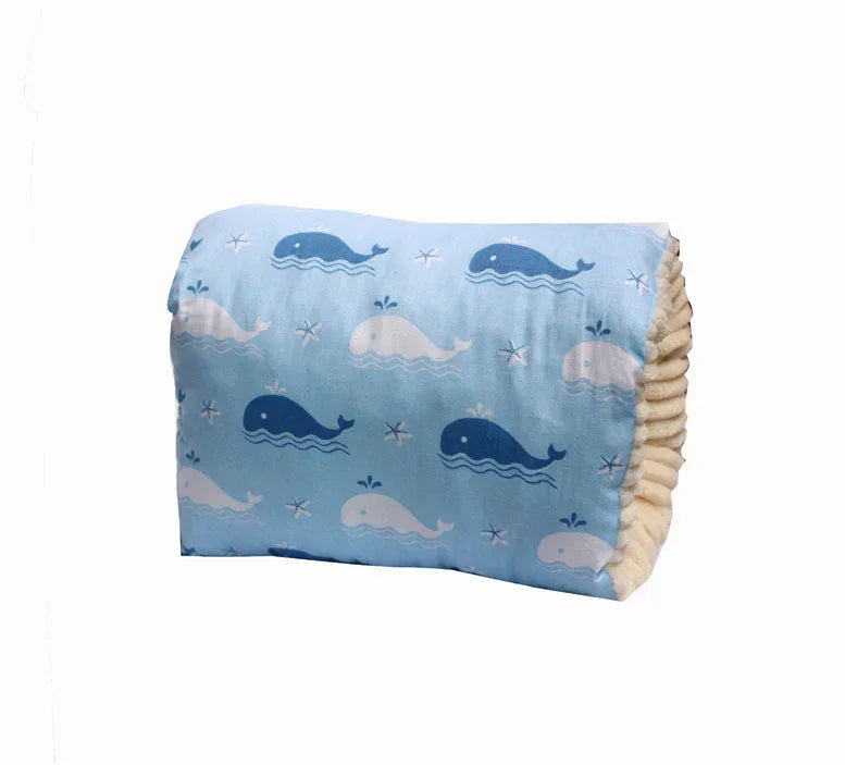 Light blue pillow with soft fabric, whale print pattern, and plush texture, kids' room decor