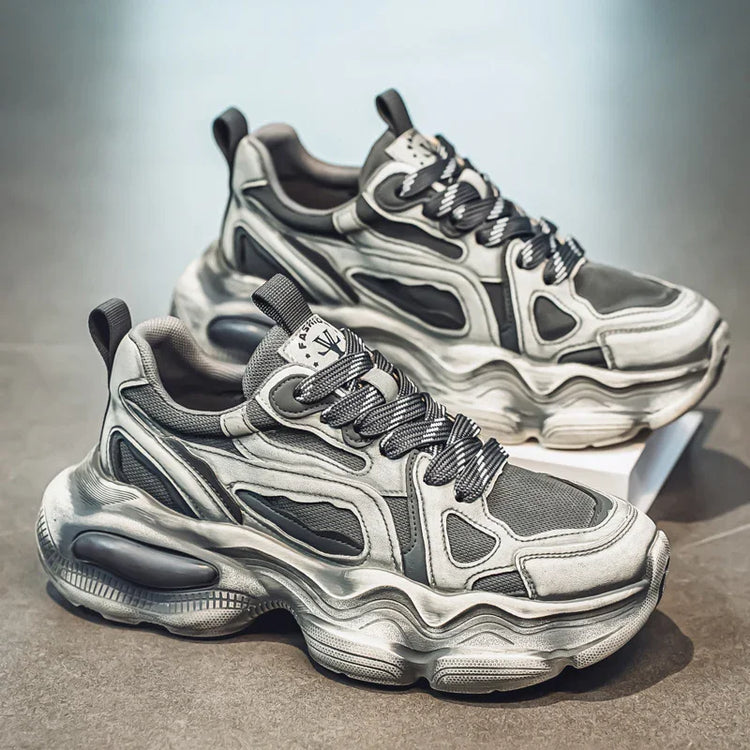Chunky futuristic gray mesh and synthetic sneakers with thick textured soles