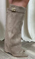 Taupe suede knee-high boots with pointed toe, loose fit, and gold buckle detail