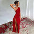 Woman wearing a red one-shoulder asymmetrical gown with thigh-high slit, fitted style