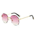 Rimless sunglasses with scalloped pink gradient lenses, gold metal arms, and black temple tips