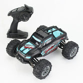 Black and blue remote control off-road truck with rugged tires and handheld controller